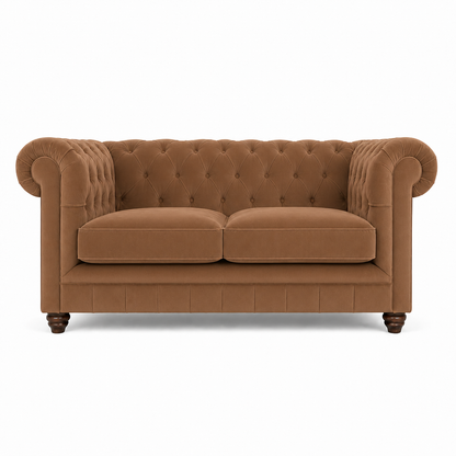 A classic Chesterfield loveseat sofa upholstered in a warm camel brown fabric, featuring deep button tufting on the backrest, rolled arms, two loose seat cushions, and dark wooden legs, shown against a plain white background.
