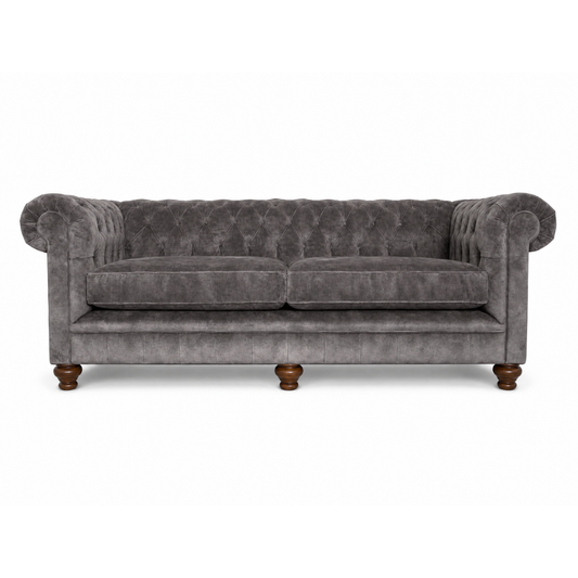 Gray velvet sofa with wooden legs on a white background