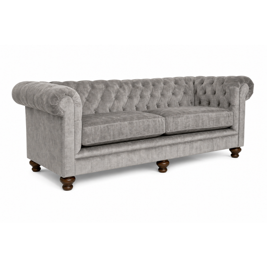 Gray tufted sofa with wooden legs on a white background