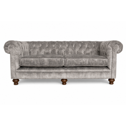 Gray velvet sofa with wooden legs on a white background