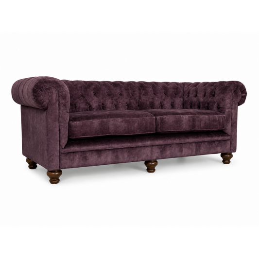 Purple velvet sofa on a white background