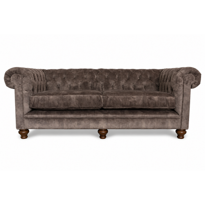 Brown velvet sofa with wooden legs on a white background