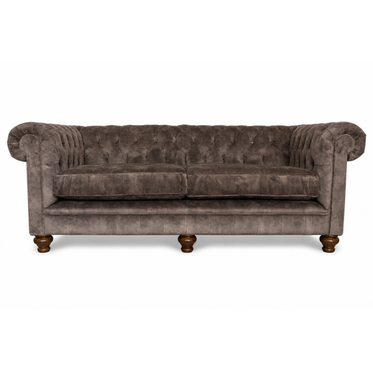 Brown velvet sofa with wooden legs on a white background