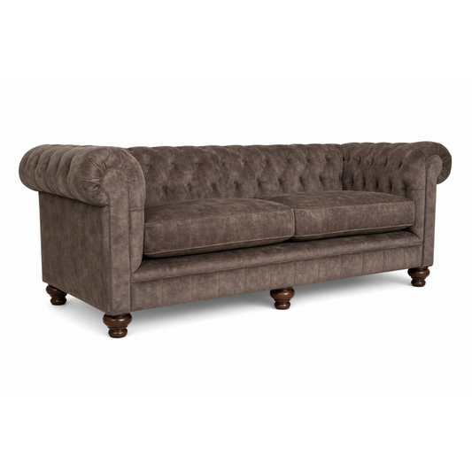 Brown sofa with tufted backrest on a white background