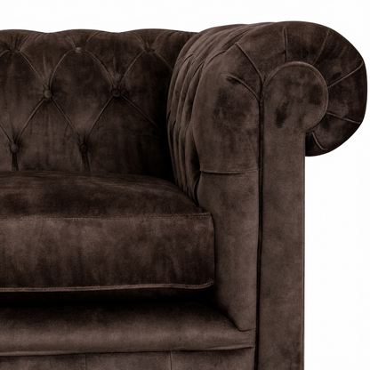 Brown velvet sofa with tufted backrest on a white background