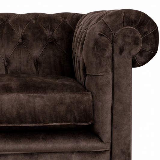 Brown velvet sofa with tufted backrest on a white background