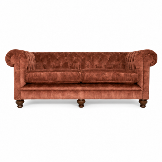 Orange velvet sofa on a white background