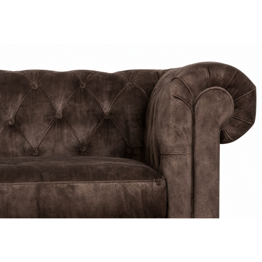 Brown velvet sofa with tufted backrest on a white background