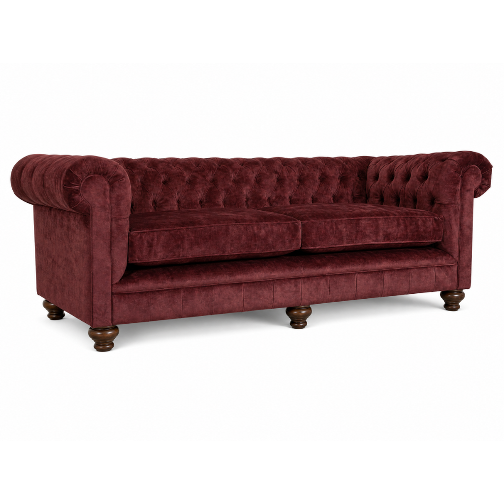 Maroon velvet sofa with tufted backrest on a white background