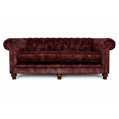Maroon velvet sofa on a white background