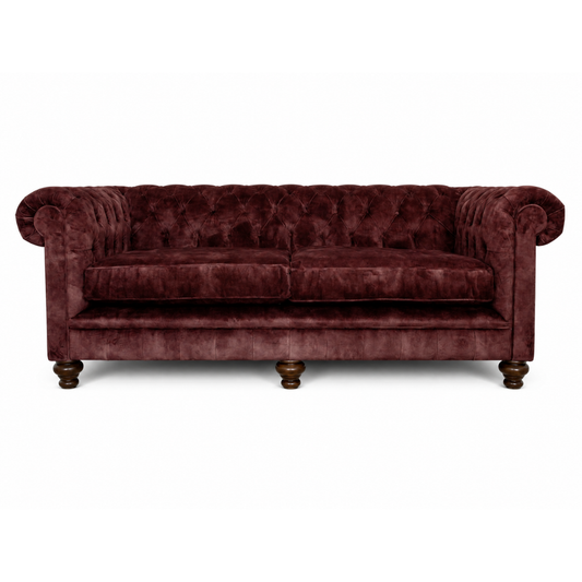 Maroon velvet sofa on a white background