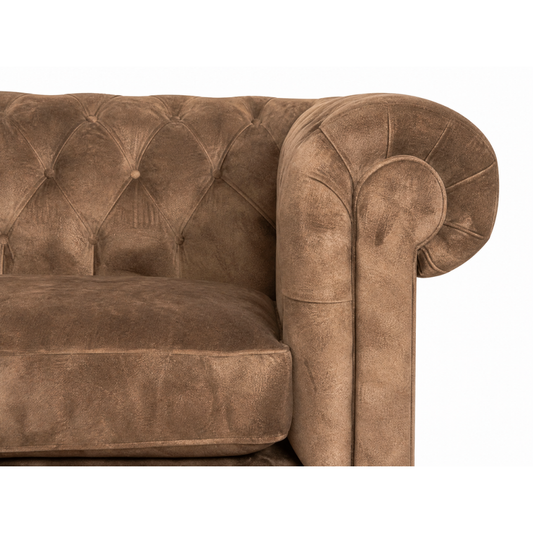 Brown velvet sofa with tufted backrest on a white background