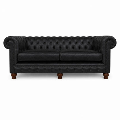Black leather sofa with tufted backrest on a white background