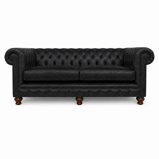 Black leather sofa with tufted backrest on a white background