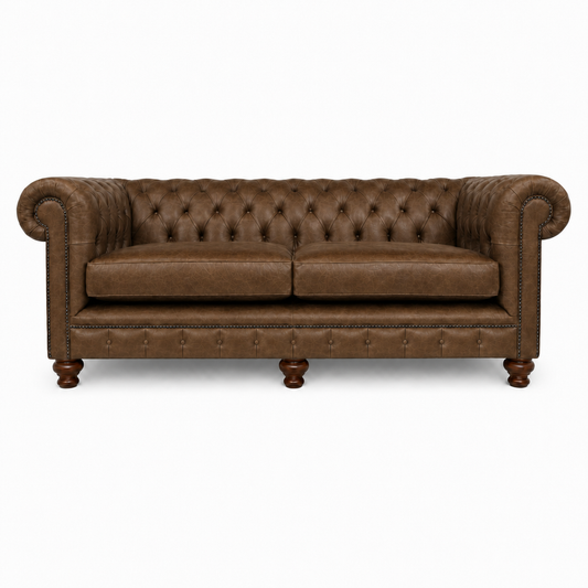 Brown leather sofa with tufted backrest on a white background