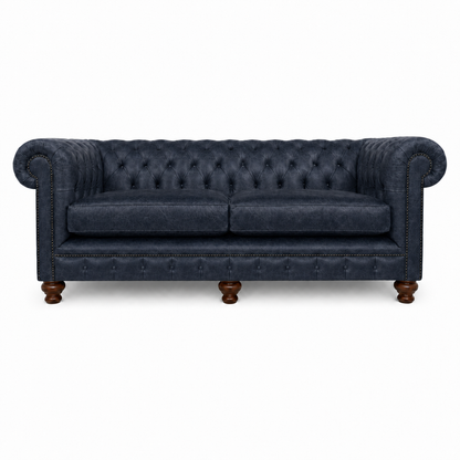 Navy blue sofa with tufted backrest on a white background