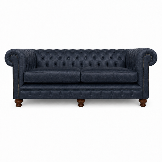 Navy blue sofa with tufted backrest on a white background