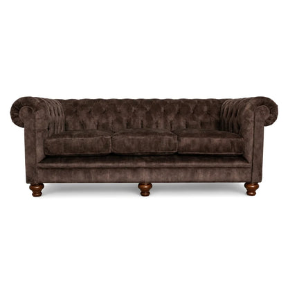 Brown velvet sofa with wooden legs on a white background