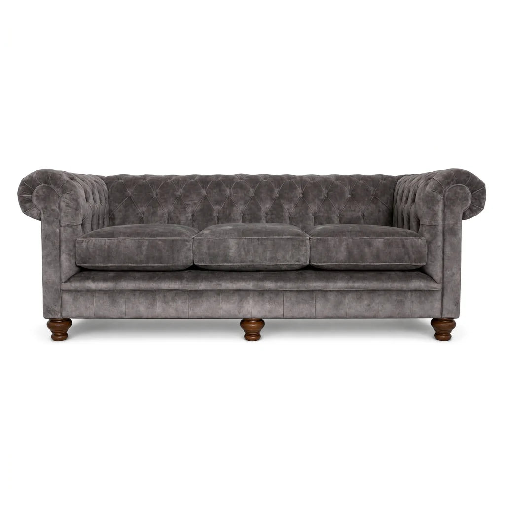 Gray velvet sofa with wooden legs on a white background