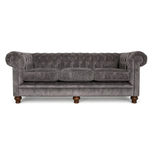 Gray velvet sofa with wooden legs on a white background