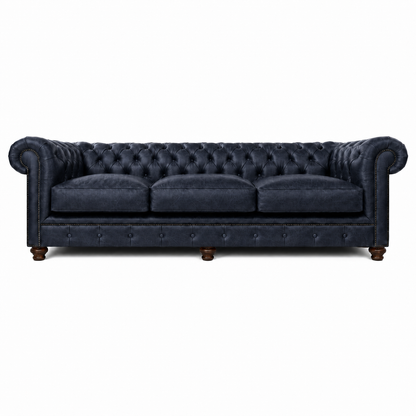 Navy blue tufted sofa on a white background