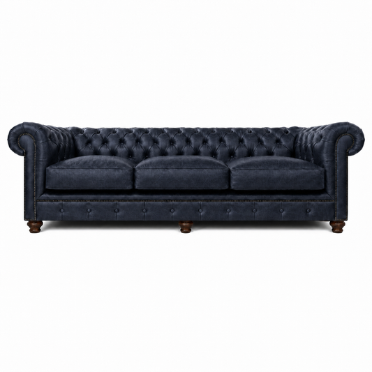 Navy blue tufted sofa on a white background