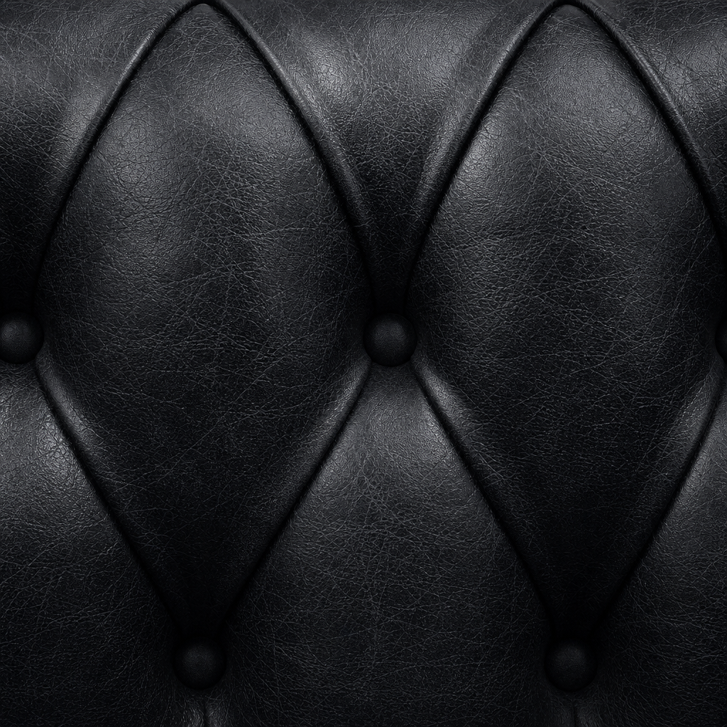 Close-up of black leather upholstery with diamond pattern