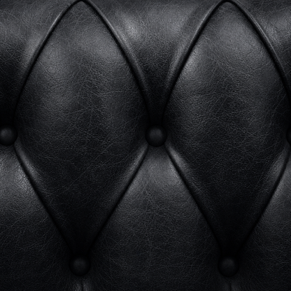 Close-up of black leather upholstery with diamond pattern