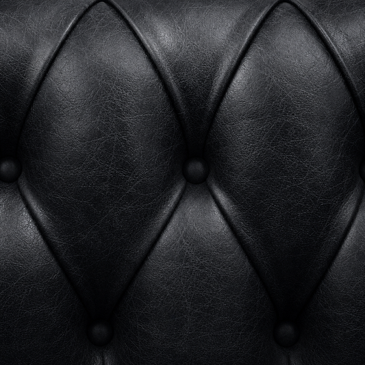 Close-up of black leather upholstery with diamond pattern