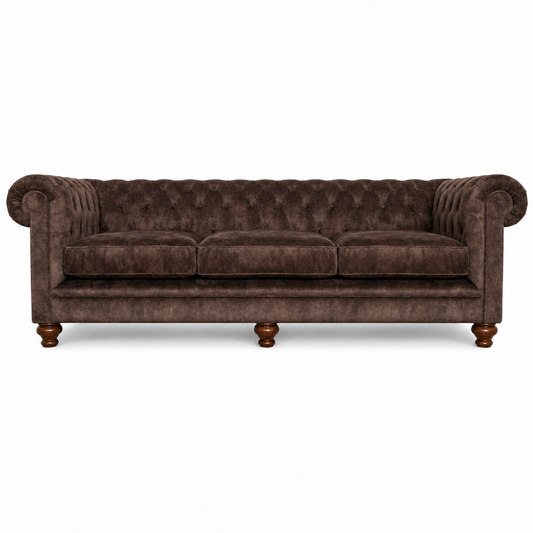 A classic Chesterfield-style three-seater sofa upholstered in dark brown velvet, featuring deep button tufting, rolled arms, and turned wooden legs, shown against a plain white background.