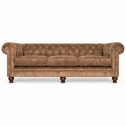 A classic Chesterfield-style sofa upholstered in brown tufted velvet, featuring rolled arms, three seat cushions, and turned wooden legs, shown against a plain white background.