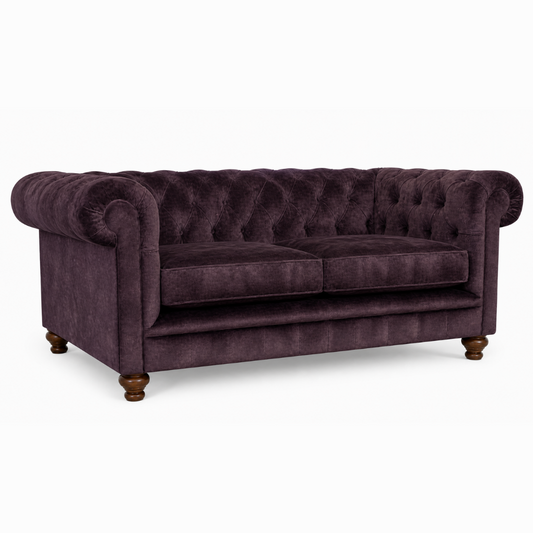 Purple velvet sofa on a white background