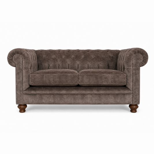 Brown velvet sofa with wooden legs on a white background