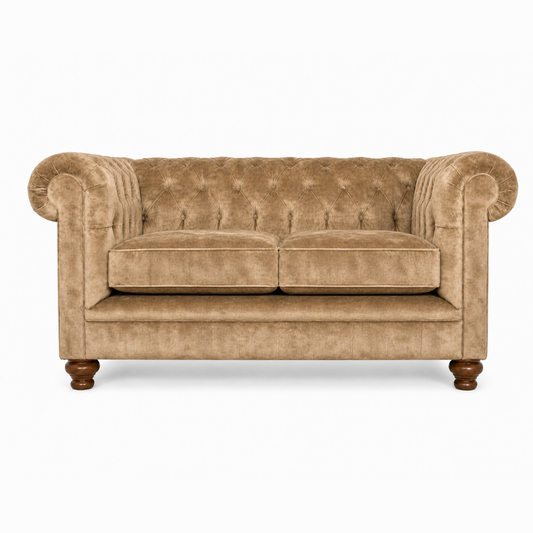 Brown velvet sofa with tufted backrest on a white background