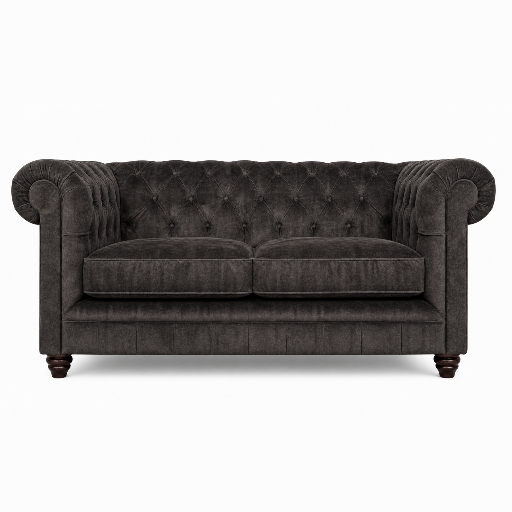 Dark gray tufted sofa on a white background