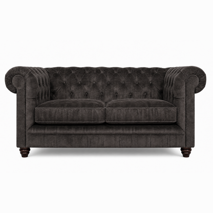 Dark gray tufted sofa on a white background