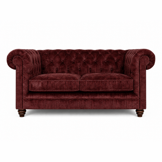 Maroon velvet sofa on a white background