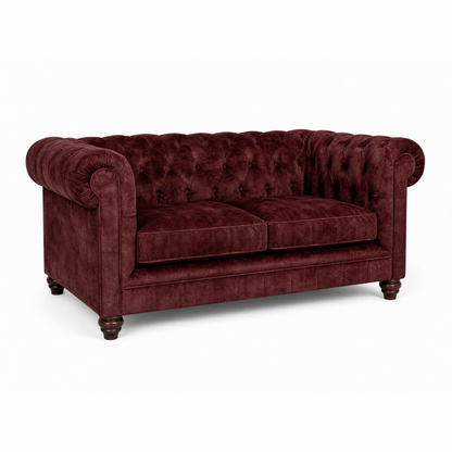 Maroon velvet sofa on a white background