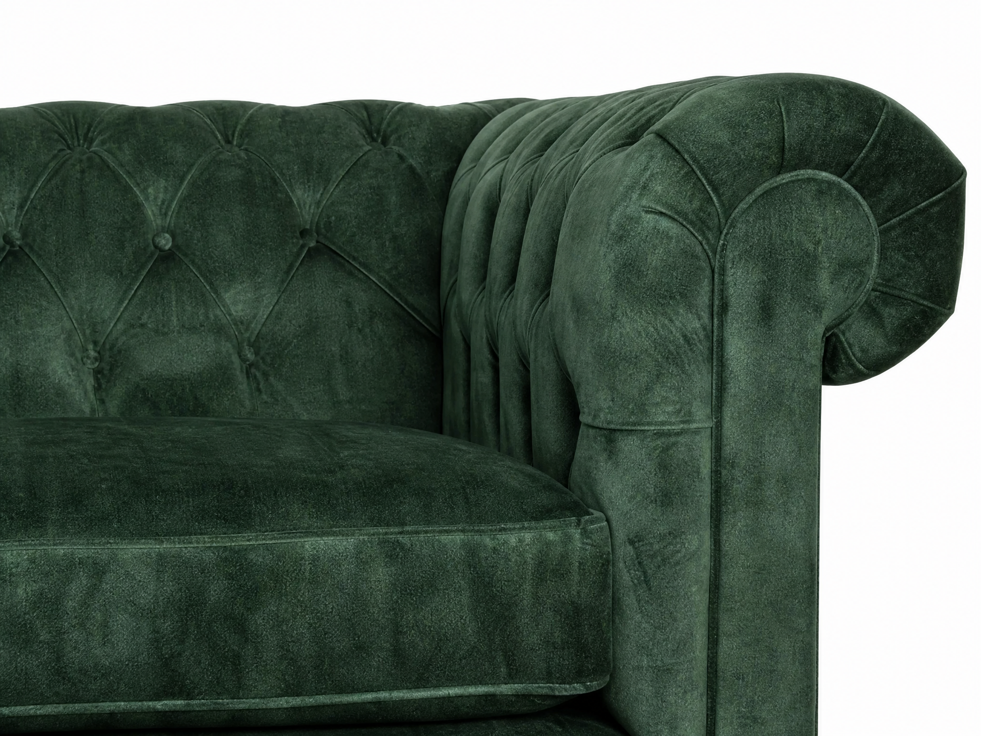 Green velvet sofa with tufted backrest on a white background