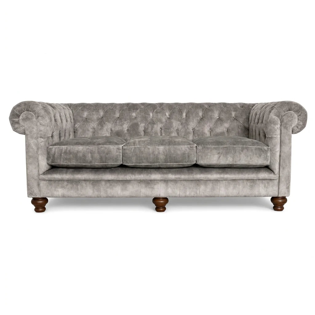 Gray velvet sofa with wooden legs on a white background