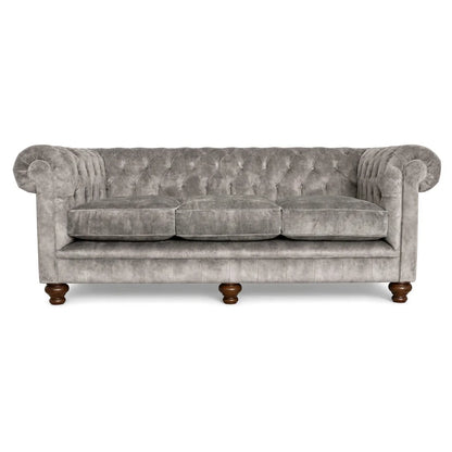 Gray velvet sofa with wooden legs on a white background