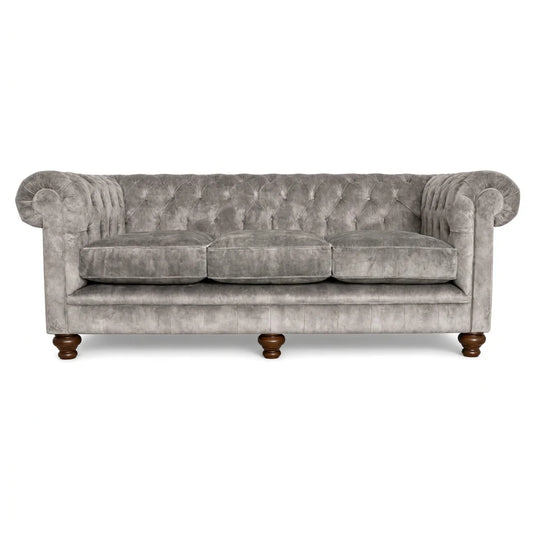 Gray velvet sofa with wooden legs on a white background