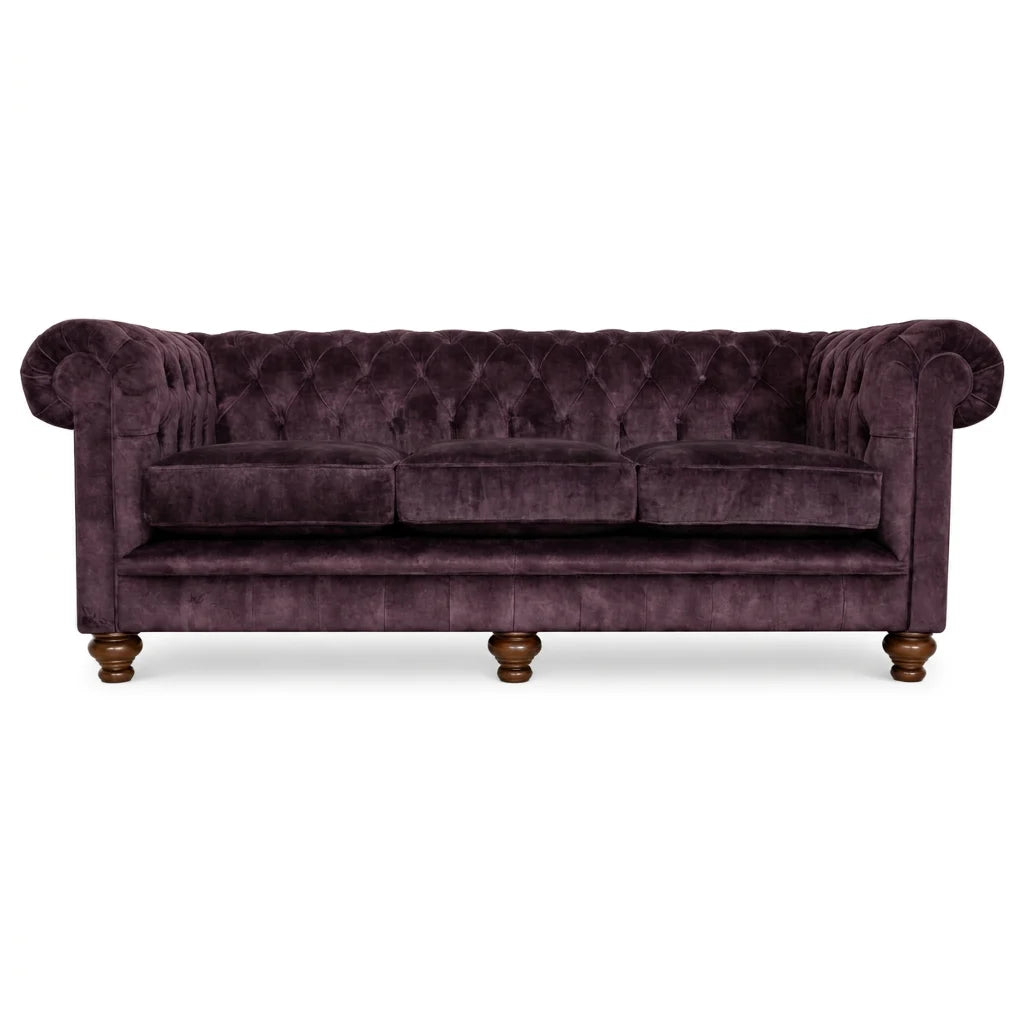Purple velvet 4 seater sofa on white bakcground 
