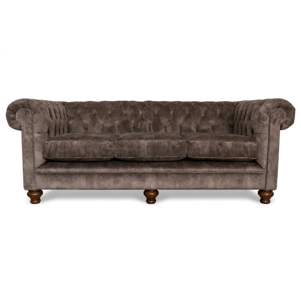 Brown velvet sofa with tufted backrest on a white background