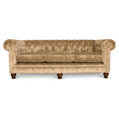 Beige velvet sofa with wooden legs on a white background