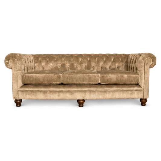 Beige velvet sofa with wooden legs on a white background