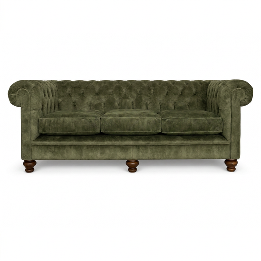 Green velvet sofa with wooden legs on a white background