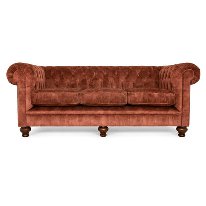 Brown velvet sofa with wooden legs on a white background