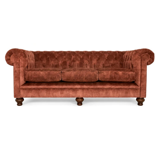 Brown velvet sofa with wooden legs on a white background