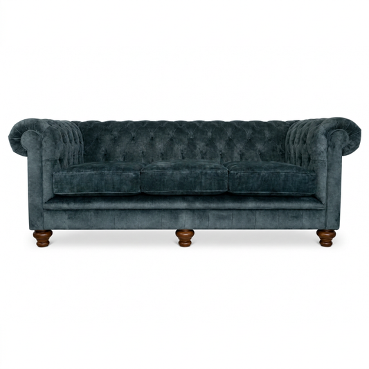 Blue velvet sofa with wooden legs on a white background